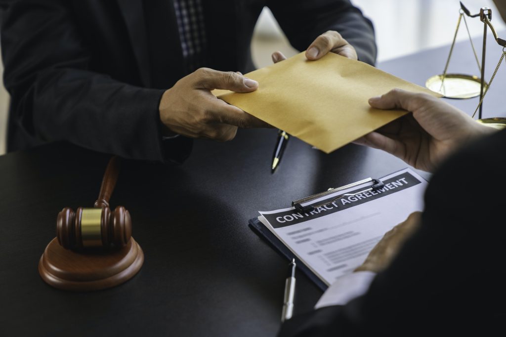 lawyer or judge is taking a bribe. In the client's courtroom at the lawyer's office In order to brib